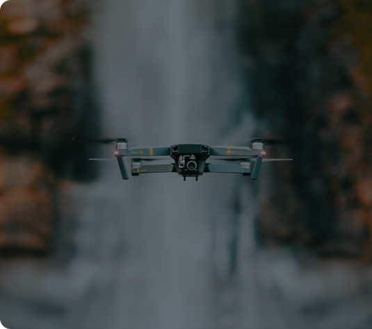 RC drone in front of waterfall